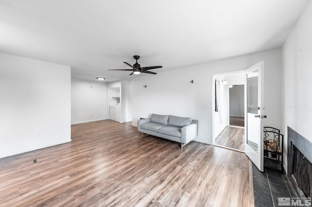 living room with ceiling fan and hardwood / wood-style flooring