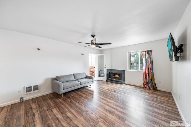 unfurnished living room with ceiling fan and dark hardwood / wood-style flooring