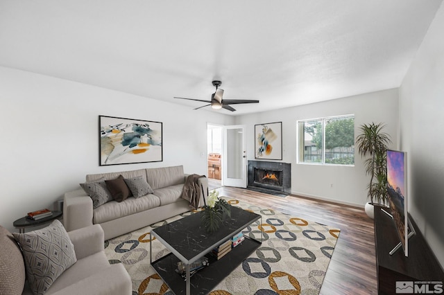 living room featuring hardwood / wood-style flooring and ceiling fan