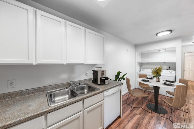 kitchen with sink, dark hardwood / wood-style floors, white cabinets, and white dishwasher