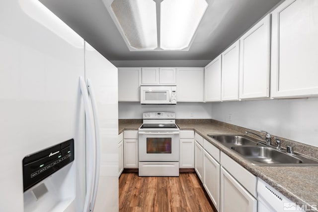 kitchen featuring sink, white appliances, white cabinets, and dark hardwood / wood-style flooring