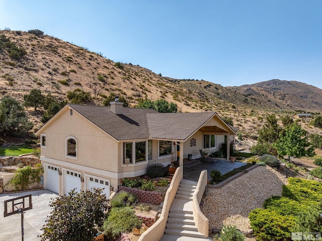 view of front facade with a mountain view and a garage