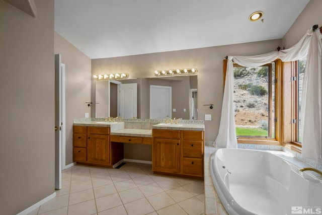 bathroom with dual vanity, tile patterned floors, a bathing tub, and plenty of natural light