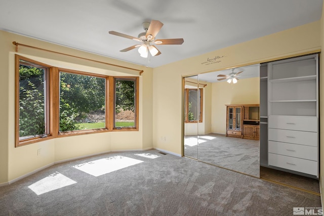 unfurnished bedroom featuring a closet, carpet flooring, and ceiling fan