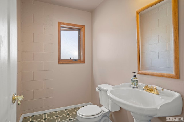 bathroom featuring tile patterned flooring, toilet, and sink