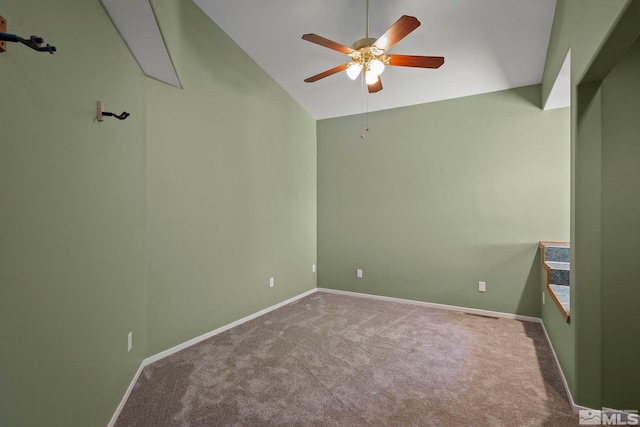 spare room featuring vaulted ceiling, ceiling fan, and carpet flooring