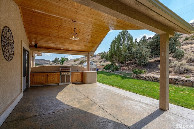 view of patio / terrace featuring area for grilling and a mountain view