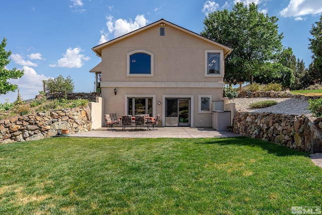 back of house with a patio area and a yard