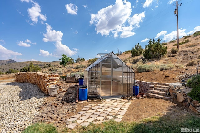 view of outbuilding with a mountain view