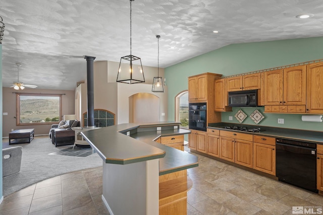 kitchen featuring black appliances, ceiling fan, a center island, light colored carpet, and vaulted ceiling