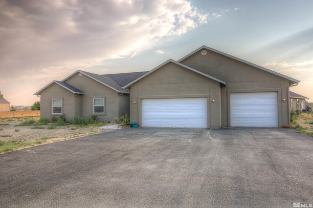 ranch-style home featuring a garage