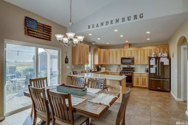 tiled dining space with sink, a chandelier, and vaulted ceiling