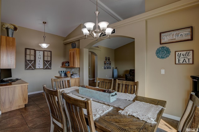 tiled dining space with lofted ceiling and a chandelier