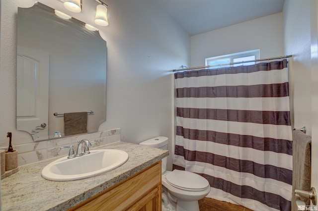 bathroom featuring toilet, a shower with curtain, and vanity