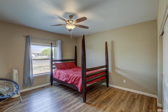 bedroom with ceiling fan and wood-type flooring