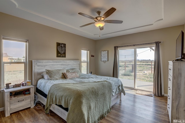 bedroom featuring ceiling fan, access to exterior, and hardwood / wood-style floors