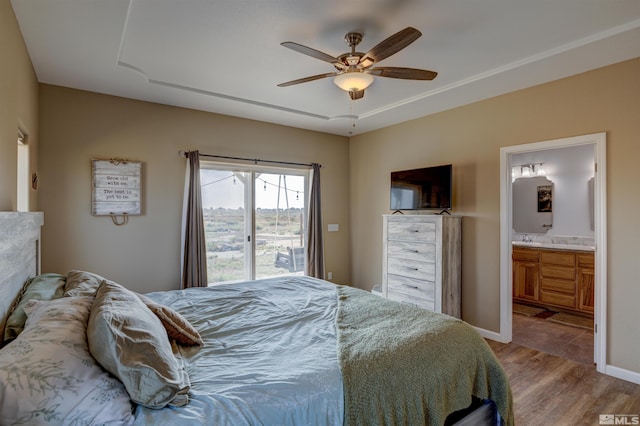 bedroom with ensuite bath, ceiling fan, and light wood-type flooring