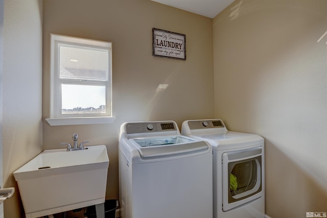 washroom featuring washer and dryer and sink