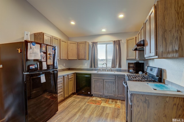 kitchen featuring light hardwood / wood-style flooring, vaulted ceiling, black appliances, and sink