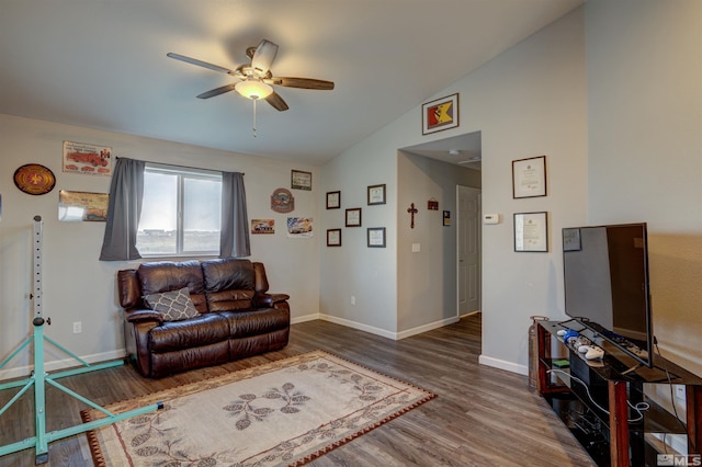 living room with ceiling fan, dark wood-type flooring, and vaulted ceiling