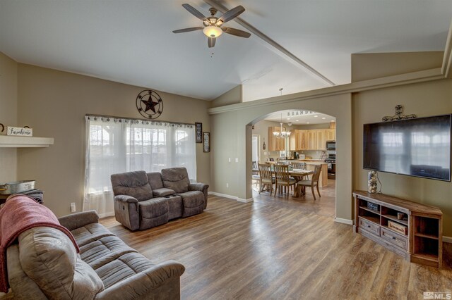 living room featuring lofted ceiling, wood-type flooring, and ceiling fan