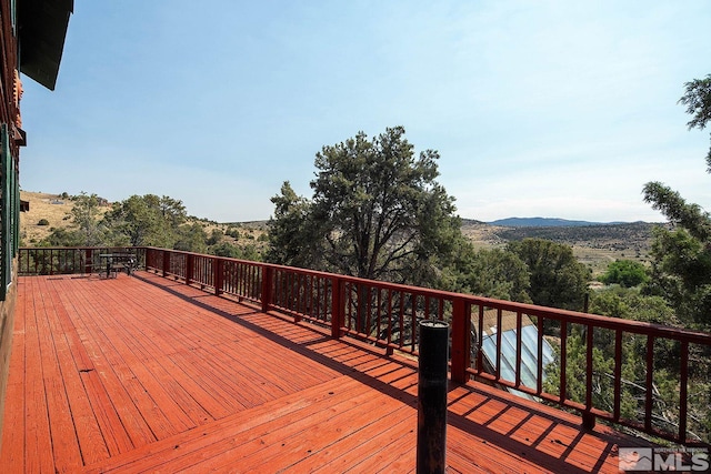 wooden deck featuring a mountain view