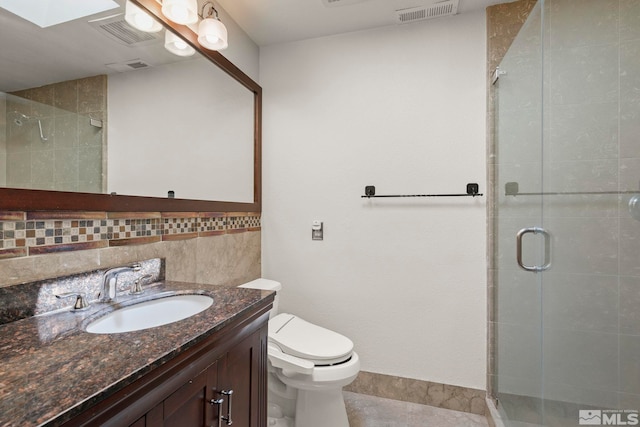 bathroom with decorative backsplash, vanity, walk in shower, toilet, and tile patterned floors