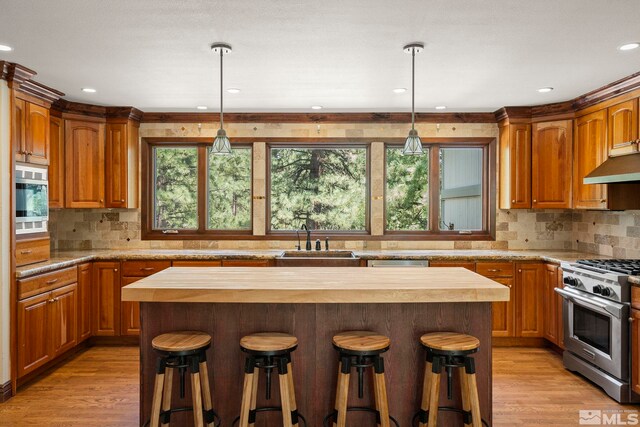 kitchen with a kitchen island, hanging light fixtures, and stainless steel appliances