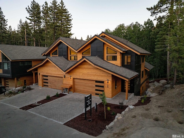 log-style house with a garage