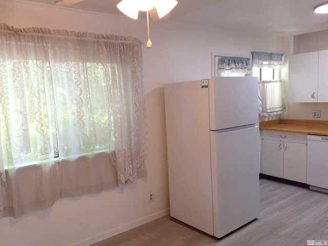 kitchen with white cabinetry, white appliances, and light wood-type flooring