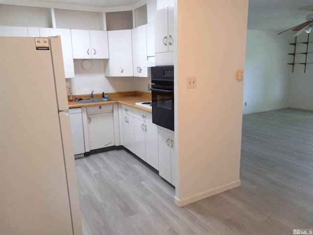 kitchen featuring light wood-type flooring, white appliances, sink, and white cabinets