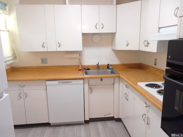 kitchen featuring white cabinetry, sink, light wood-type flooring, wooden counters, and white appliances