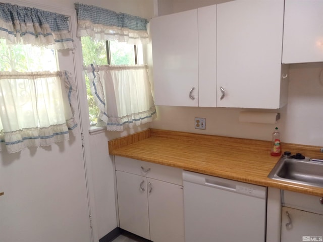 kitchen with dishwasher, a healthy amount of sunlight, sink, and white cabinets