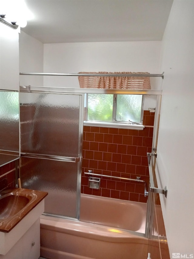 bathroom with vanity and combined bath / shower with glass door