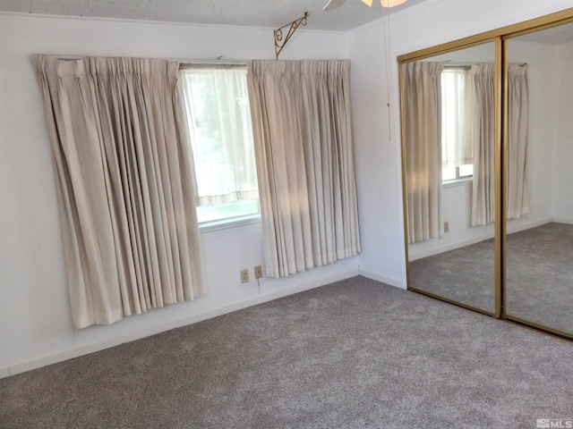 unfurnished bedroom with carpet floors and a closet