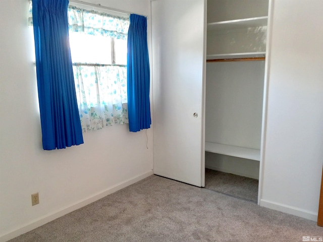 unfurnished bedroom with carpet flooring and a closet