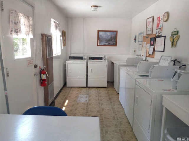 clothes washing area with washing machine and dryer