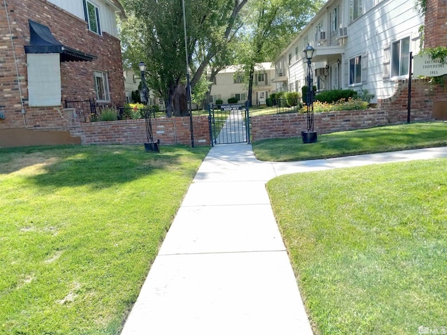 view of property's community with a lawn