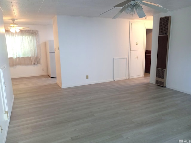 unfurnished room featuring ceiling fan and light hardwood / wood-style floors