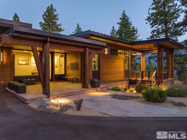 back house at dusk with a patio