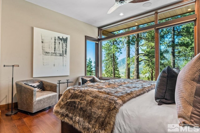 bedroom with wood-type flooring and ceiling fan