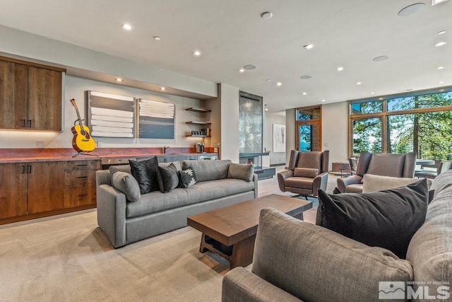 living room with expansive windows and light carpet