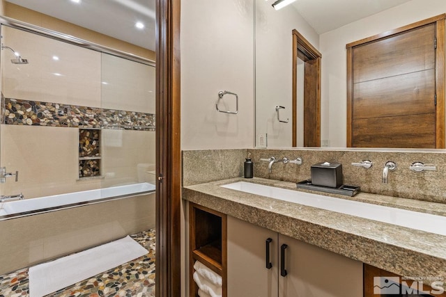 bathroom featuring tasteful backsplash and vanity