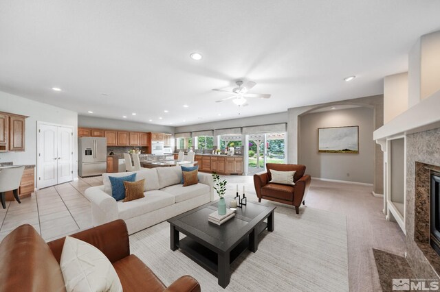 kitchen featuring a center island, light stone countertops, light tile patterned floors, and a kitchen bar