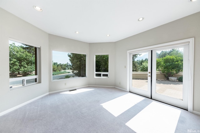 carpeted spare room with french doors