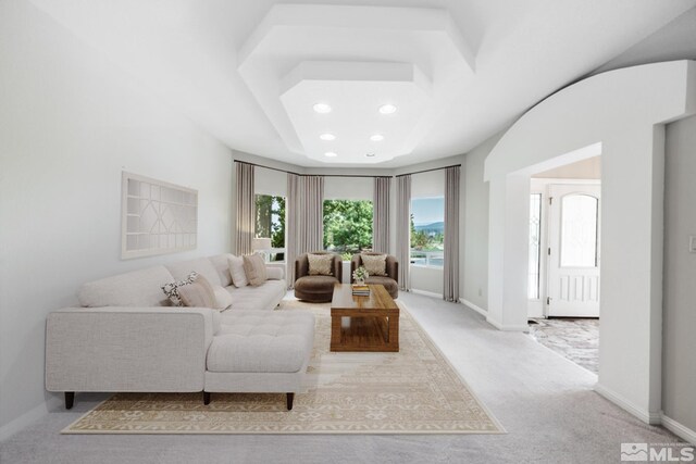 kitchen with ceiling fan, decorative backsplash, a center island, light colored carpet, and a high end fireplace