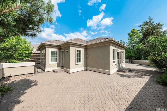 rear view of property featuring a patio