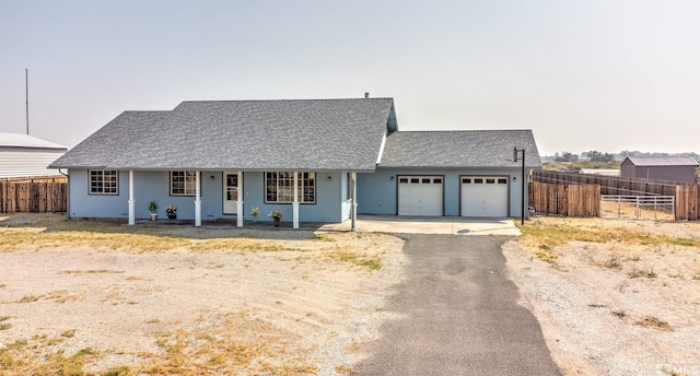 ranch-style house with a garage and covered porch