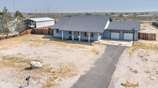 view of front facade featuring a carport, a garage, and covered porch