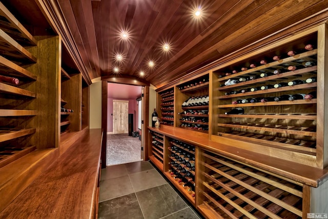 wine cellar featuring wood ceiling and dark tile patterned floors